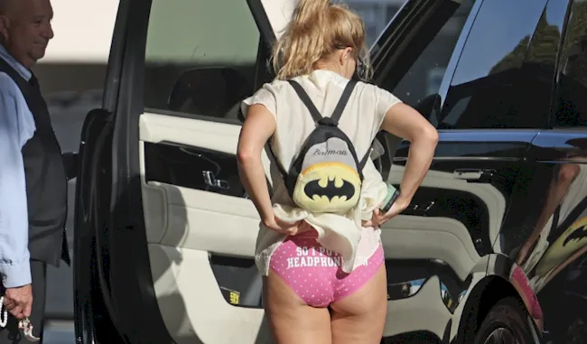 Addison Rae pulls up her dress to reveal pink panties while standing by her car